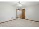 A bright bedroom featuring a neutral carpet, a ceiling fan, and an open door frame at 6742 S New Jersey St, Indianapolis, IN 46227