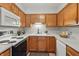 Well-lit kitchen featuring oak cabinets, white countertops, and modern appliances for a functional cooking space at 6742 S New Jersey St, Indianapolis, IN 46227