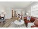 Bright living room featuring modern vinyl floors and neutral colors with an open floor plan to dining room at 6742 S New Jersey St, Indianapolis, IN 46227