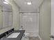 Clean bathroom with white subway tile, a shower-tub, and a large mirror above the sink at 715 Cottage Ave, Indianapolis, IN 46203