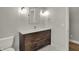 Bathroom featuring a wood vanity with a white countertop, and white penny tile floors at 715 Cottage Ave, Indianapolis, IN 46203
