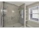 Modern bathroom featuring a glass shower, marble tile and white shelves at 715 Cottage Ave, Indianapolis, IN 46203