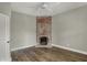Bedroom with refinished hardwood floors and exposed brick fireplace at 715 Cottage Ave, Indianapolis, IN 46203