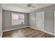 A bright bedroom with a ceiling fan, hardwood floors, a window and a mini AC unit at 715 Cottage Ave, Indianapolis, IN 46203