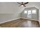 Spacious bedroom featuring wood look floors, ample lighting, neutral colors and 3 windows at 715 Cottage Ave, Indianapolis, IN 46203