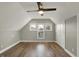 Spacious bedroom featuring wood look floors, ample lighting, neutral colors and 3 windows at 715 Cottage Ave, Indianapolis, IN 46203
