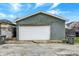 A detached garage is featured in this backyard with trash cans at 715 Cottage Ave, Indianapolis, IN 46203