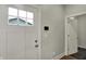 Hallway features a white door with a window and a smart home control panel at 715 Cottage Ave, Indianapolis, IN 46203
