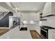 Open kitchen features white cabinets, stainless steel appliances, and a large center island for food preparation at 715 Cottage Ave, Indianapolis, IN 46203