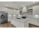Modern kitchen with white cabinets, stainless steel appliances, and a large island with bar seating at 715 Cottage Ave, Indianapolis, IN 46203