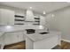 Stylish kitchen with pendant lighting, quartz countertops, stainless steel appliances, and dark wood shelving at 715 Cottage Ave, Indianapolis, IN 46203