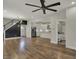 Expansive open-concept living room with hardwood floors, modern fixtures, and view to kitchen at 715 Cottage Ave, Indianapolis, IN 46203