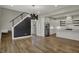 Open floor plan with a modern staircase, stainless steel appliances, and a well-lit kitchen at 715 Cottage Ave, Indianapolis, IN 46203