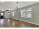 Spacious living room showcasing hardwood floors, large windows, and contemporary lighting at 715 Cottage Ave, Indianapolis, IN 46203