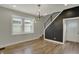 Bright living room featuring hardwood floors, lots of natural light, and modern lighting fixtures at 715 Cottage Ave, Indianapolis, IN 46203