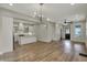 Open concept living area with kitchen island, hardwood floors, and plenty of natural light at 715 Cottage Ave, Indianapolis, IN 46203