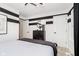 Modern bedroom with black and white striped walls, sleek furniture, and ample natural light at 7342 Shroyer Way, Noblesville, IN 46062