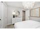 Bright bedroom features a modern light fixture, dresser and mirror with access to the bathroom at 7342 Shroyer Way, Noblesville, IN 46062