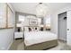 Stylish bedroom with a unique chandelier, western-themed artwork, and a window view at 7342 Shroyer Way, Noblesville, IN 46062