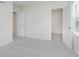 Bright bedroom featuring carpet, two doorways, and a window with blinds at 7342 Shroyer Way, Noblesville, IN 46062