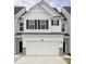 Charming two-story townhouse with a white facade, black shutters, and a spacious two-car garage at 7342 Shroyer Way, Noblesville, IN 46062