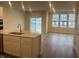 Modern kitchen with stainless steel sink, quartz countertops, and an open layout towards the living space at 7342 Shroyer Way, Noblesville, IN 46062