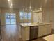 Stylish kitchen with stainless steel appliances, a central island with quartz countertops, and an open living area at 7342 Shroyer Way, Noblesville, IN 46062