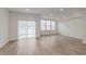 Living room with sliding glass door, multiple windows, and wood-look flooring at 7342 Shroyer Way, Noblesville, IN 46062