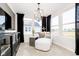 Cozy sitting area with large windows, modern chaise lounge, and stylish decor at 7342 Shroyer Way, Noblesville, IN 46062