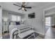 Bedroom with ceiling fan, plank flooring, comfortable bed, decorative pillows, and mounted TV at 7668 Heather Dr, Nineveh, IN 46164