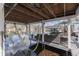 Inviting outdoor space featuring lake views, a covered deck with comfortable seating, and a hammock, perfect for relaxation at 7668 Heather Dr, Nineveh, IN 46164