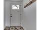 Bright entryway with a white door, decorative wreath, coat rack, and a colorful rug creating a welcoming ambiance at 7668 Heather Dr, Nineveh, IN 46164