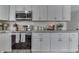 Kitchen view featuring stainless steel appliances and white cabinets with silver hardware at 7668 Heather Dr, Nineveh, IN 46164