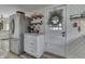 A quaint kitchenette features a stainless steel fridge and white cabinets at 7668 Heather Dr, Nineveh, IN 46164
