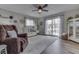 Bright and inviting living room with a ceiling fan, neutral furniture, and access to an outdoor deck through sliding doors at 7668 Heather Dr, Nineveh, IN 46164