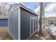 Outbuilding near lake with painted horizontal siding and white trim at 7668 Heather Dr, Nineveh, IN 46164