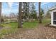 Spacious backyard with mature trees, a lush lawn, and space for outdoor activities at 7811 Hoover Rd, Indianapolis, IN 46260