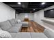 Finished basement with hardwood floors, recessed lighting, and a comfortable seating area at 7811 Hoover Rd, Indianapolis, IN 46260