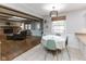 Open dining area with table next to a living room with wood beams and brick fireplace at 7811 Hoover Rd, Indianapolis, IN 46260
