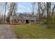 Charming two-story home with brick and siding exterior, mature trees and well-maintained lawn at 7811 Hoover Rd, Indianapolis, IN 46260