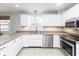 Modern kitchen featuring white cabinets, granite counters, stainless appliances, and tile floors at 7811 Hoover Rd, Indianapolis, IN 46260