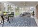 Relaxing screened-in porch with comfortable seating, a ceiling fan, and a view of the backyard at 7811 Hoover Rd, Indianapolis, IN 46260