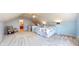Spacious bedroom with carpet, sloped ceiling, ceiling fan, and seating area with armchair at 7971 Cool Hollow Pl, Indianapolis, IN 46237
