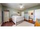 Comfortable bedroom featuring an ensuite bathroom, hardwood floors, and a ceiling fan at 7971 Cool Hollow Pl, Indianapolis, IN 46237