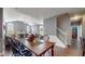 Open concept dining area featuring a wooden table, black chairs, and hardwood floors at 7971 Cool Hollow Pl, Indianapolis, IN 46237