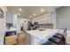 Modern kitchen with gray cabinets, quartz countertops, and a breakfast bar at 7971 Cool Hollow Pl, Indianapolis, IN 46237
