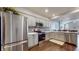 Modern kitchen with stainless steel appliances, gray cabinets, and granite countertops at 7971 Cool Hollow Pl, Indianapolis, IN 46237