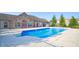 Community outdoor pool with red doors, surrounded by concrete and black fence for exclusive enjoyment at 7971 Cool Hollow Pl, Indianapolis, IN 46237