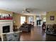 Open floor plan featuring a dining room and living room with hardwood floors and a fireplace at 804 Seabreeze Dr, Avon, IN 46123
