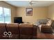 Comfortable living room with a ceiling fan, large window, and a wall decoration at 804 Seabreeze Dr, Avon, IN 46123